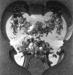 Ein Blumenfeston über einem Piedestal mit Früchten und einem grünen Papagei